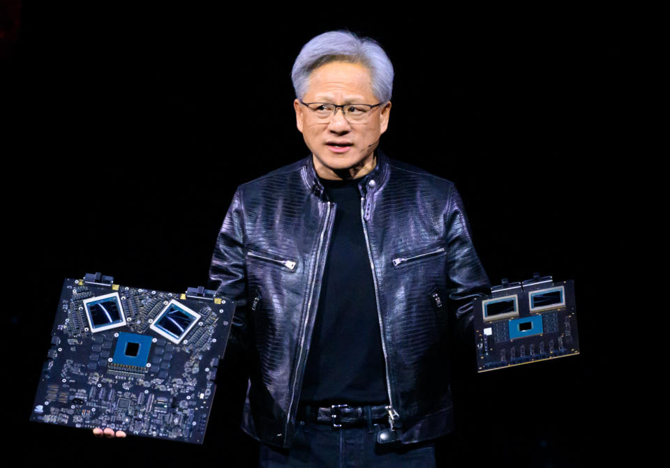 NVIDIA's CEO Jensen Huang displays products on-stage during the annual Nvidia GTC Artificial Intelligence Conference at SAP Center in San Jose, California, on March 18, 2024. (Photo by JOSH EDELSON / AFP) (Photo by JOSH EDELSON/AFP via Getty Images)