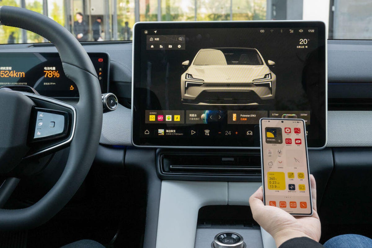 A Polestar mobile phone is shown inside a car.