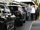 Prime Minister Justin Trudeau, left to right, Honda chief executive Toshihiro Mibe and Ontario Premier Doug Ford walk along an assembly line at an event announcing plans for a Honda electric vehicle battery plant in Alliston, Ont. on Thursday, April 25, 2024.