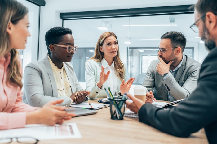 People in the workplace discussing business strategy.