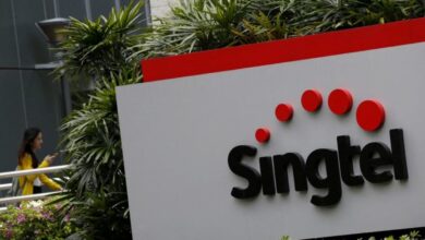 Singtel falls up to 3% after .3 billion impairment