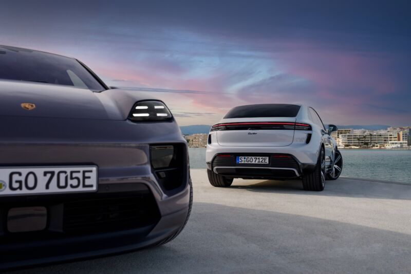 A pair of Porsche Macans parked by the water