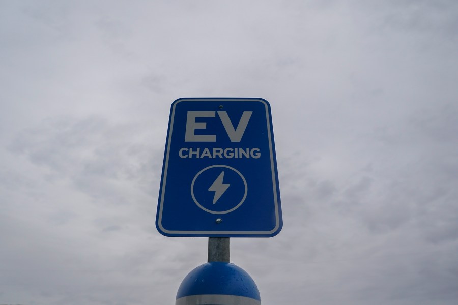 A sign sits at an electric vehicle charging station, Friday, March 8, 2024, at an electric vehicle charging station in London, Ohio. The charging ports are a key part of President Joe Biden’s effort to encourage drivers to move away from gasoline-powered cars and trucks that contribute to global warming. (AP Photo/Joshua A. Bickel)