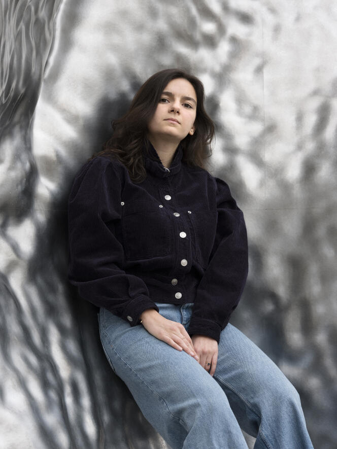 Elise Mekkaoui, in front of the sculpture by artist Urs Fischer, on the Alan Turing forecourt, where Station F is located, in Paris, on March 29, 2024.