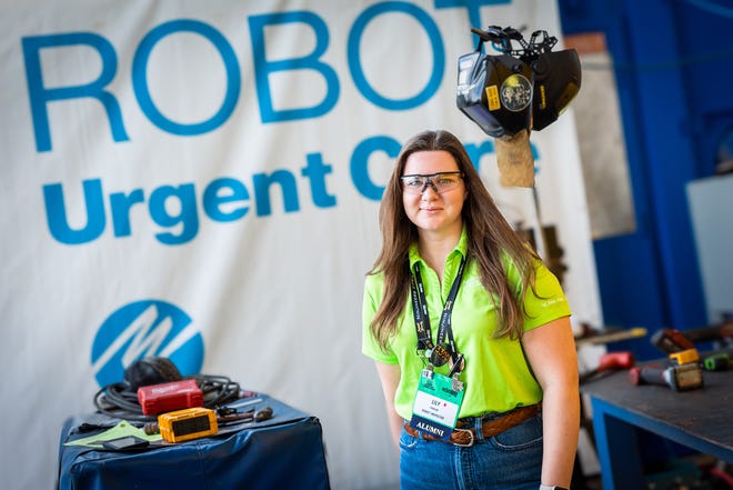 FPL employee Elizabeth Pawlak at the FIRST Robotics Competition on March 1 where hundreds of high school student built and battled robots at the competition.