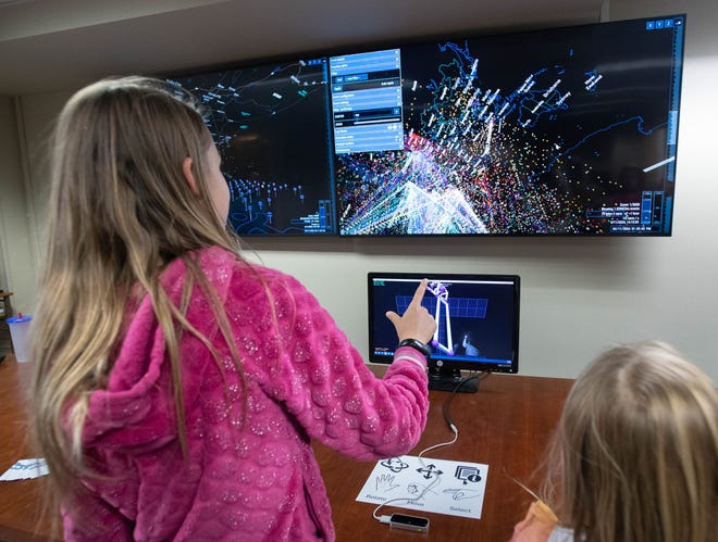 Lilly Trenka, 10, left, uses hand motions to control a computer during the IHMC open house in Pensacola on Thursday, April 11, 2024.