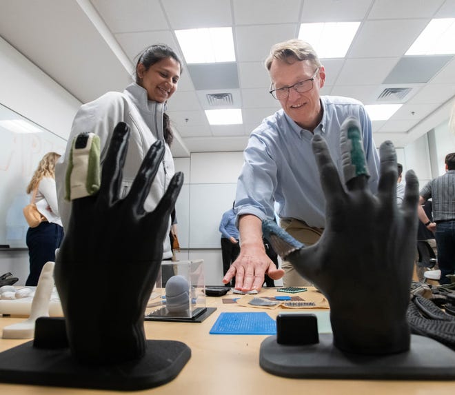 Senior research scientist Jeff Phillips, right, talks to Meghna Chatterjee about tactile research during the IHMC open house in Pensacola on Thursday, April 11, 2024.