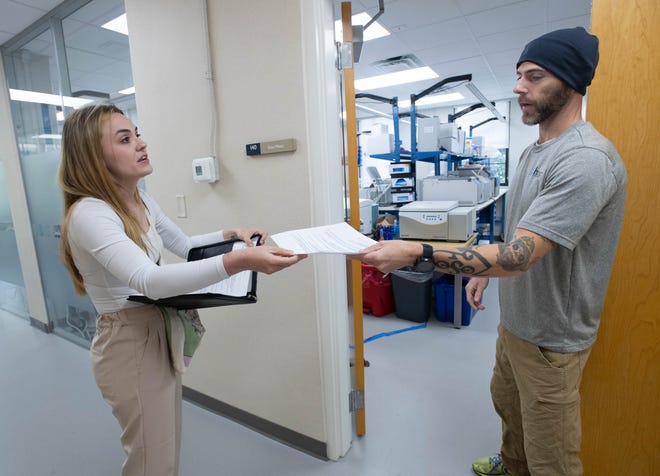 Research scientist Zachary Graham, right, talks with Elizabeth Moore, of Tallahassee, while giving her a tour of his lab during the IHMC open house in Pensacola on Thursday, April 11, 2024.