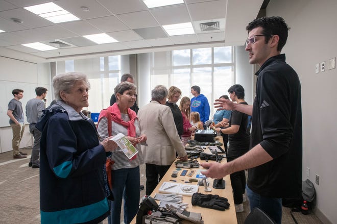 From right, research associate Landon Casey talks about tactile gloves with Diane Nash and Judy Stamper during the IHMC open house in Pensacola on Thursday, April 11, 2024.