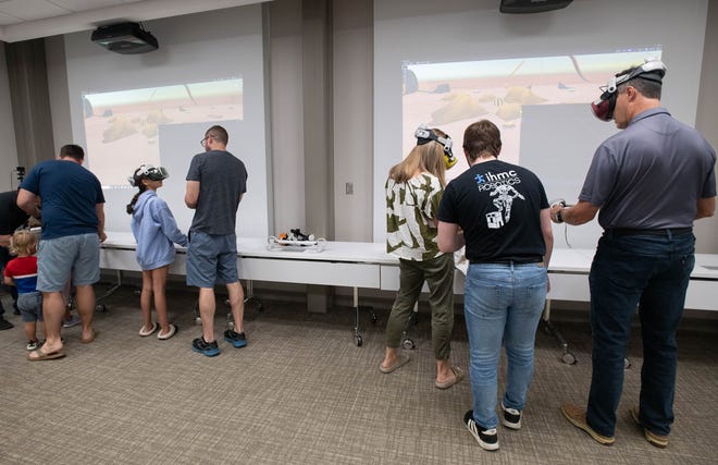 Guest try virtual reality equipment during the IHMC open house in Pensacola on Thursday, April 11, 2024.