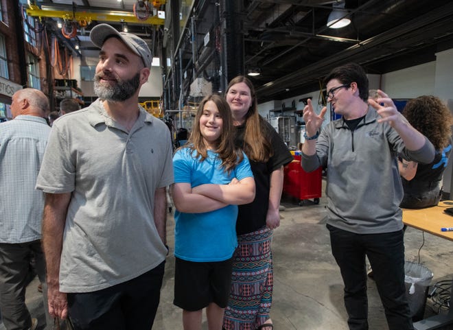 From right, engineer intern Sean Bridges talks with Lane Black, Jeremy Black, 11, and Michael Black, of Niceville, in the Robotics Lab during the IHMC open house in Pensacola on Thursday, April 11, 2024.