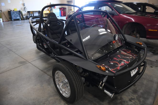 Harrisburg High School students show their assembled electric car they built in their auto shop class on Wednesday, April 24, 2024, at Tiger Stripes Garage in Harrisburg. The students will take apart and reassemble the car each semester so students can learn how to build an all electric vehicle.