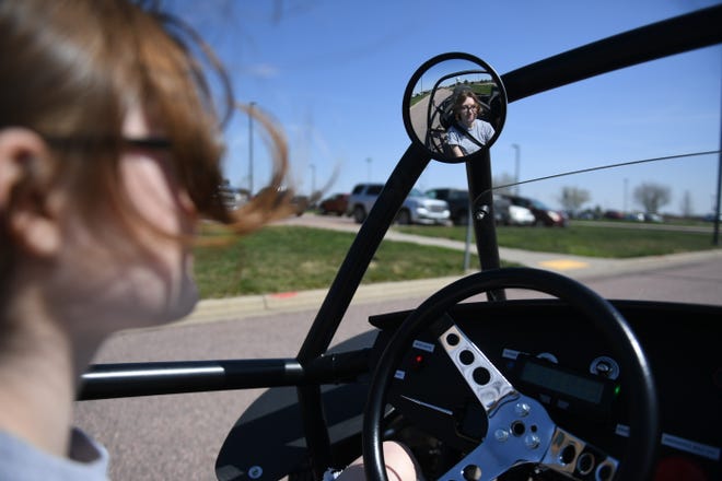 Harrisburg senior Riley Brewer, 18, drives the electric car around the school’s parking lot on Wednesday, April 24, 2024, at Tiger Stripes Garage in Harrisburg.