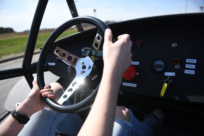 Harrisburg senior Riley Brewer, 18, drives the electric car around the school’s parking lot on Wednesday, April 24, 2024, at Tiger Stripes Garage in Harrisburg.