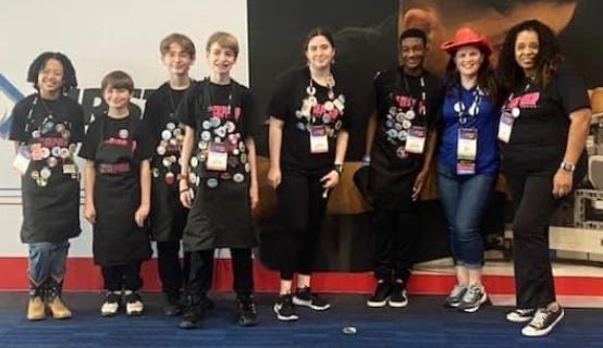 Landmark Middle's robotics team at the Lego League world championship: from left, Zoey Takamine; siblings Jayden, Briar and Carson Agidius; Grace Pendergraft; Kam'Ron Diamond; missing, Kamaurie Sutherland. Far right: Coach Avis Collier, with league rep Lesley Rester.