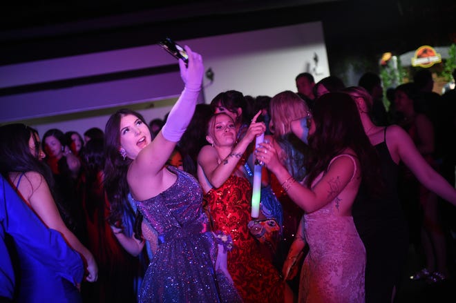 Sparks High students celebrate during their prom at the National Automobile Museum in Reno on April 27, 2024.