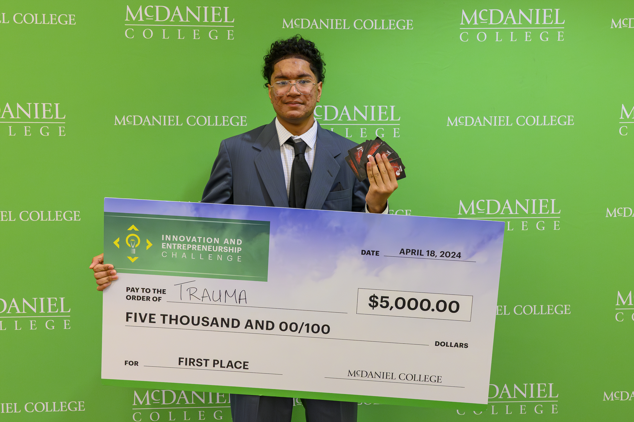 Josiah Yung poses with his card game Trauma after winning the Innovation and Entrepreneurship Challenge at McDaniel College. (Thomas Walker/Freelance)