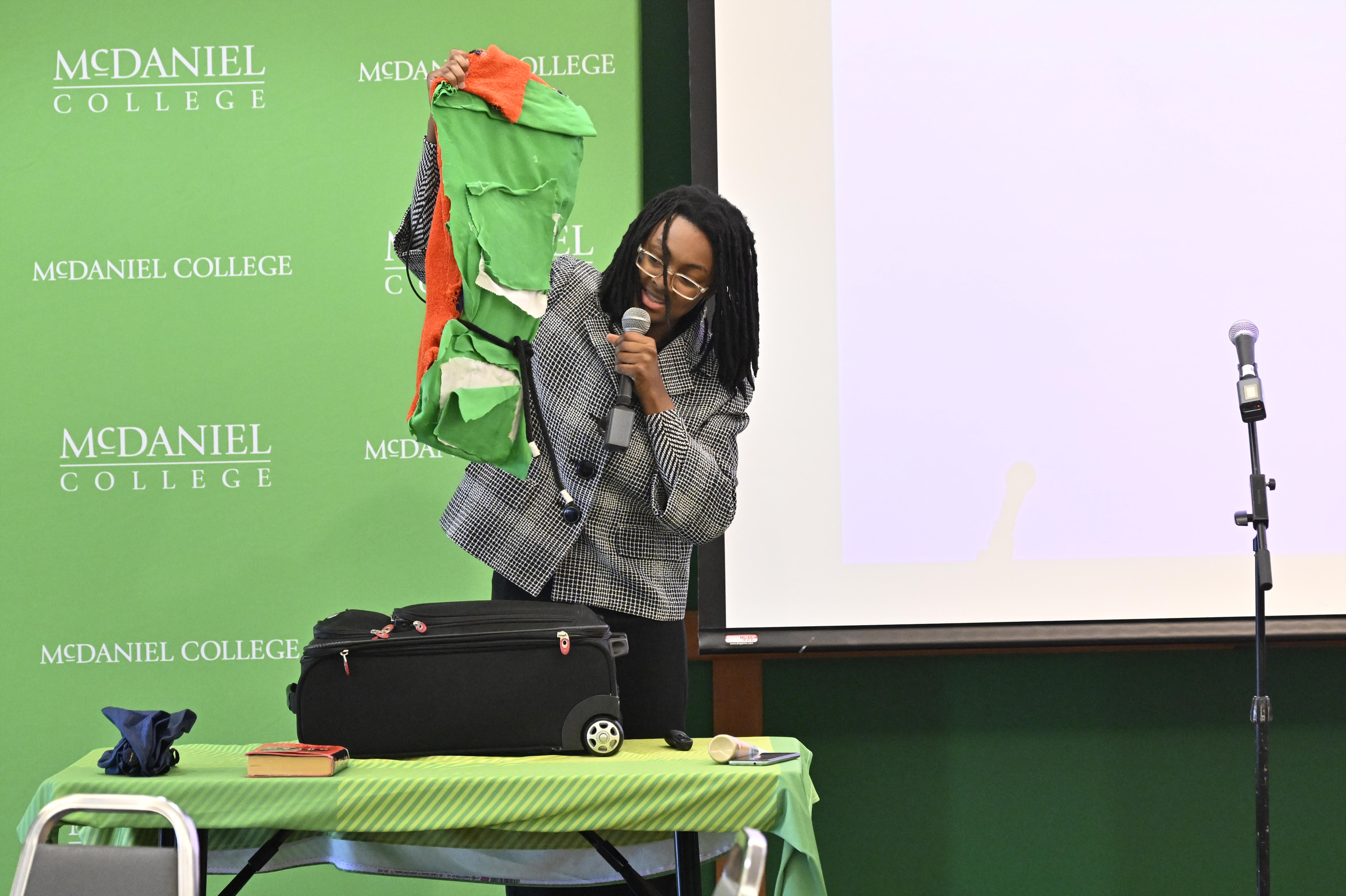 Moonasia Williams demonstrates her prototype Mecca Astro adaptable bag during the Innovation and Entrepreneurship Challenge at McDaniel College. (Thomas Walker/Freelance)