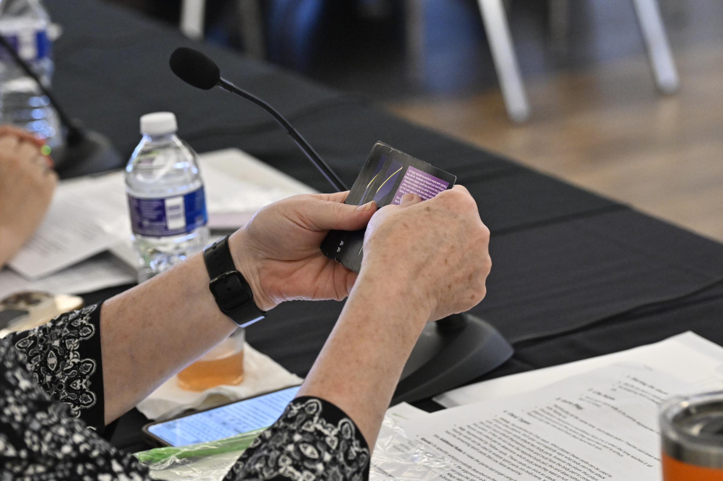 A judge looks at cards for Josiah Yung's game Trauma during the Innovation and Entrepreneurship Challenge at McDaniel College. (Thomas Walker/Freelance)