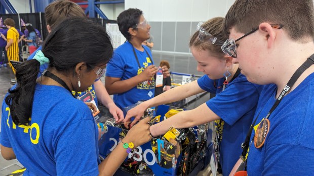 Members of Team BroomBots robotics team work on a project while at the FIRST Robotics Competition, an international challenge, in Houston, Texas, in April. (Jamie Rumsey and Julian McCoy -- Courtesy photo)