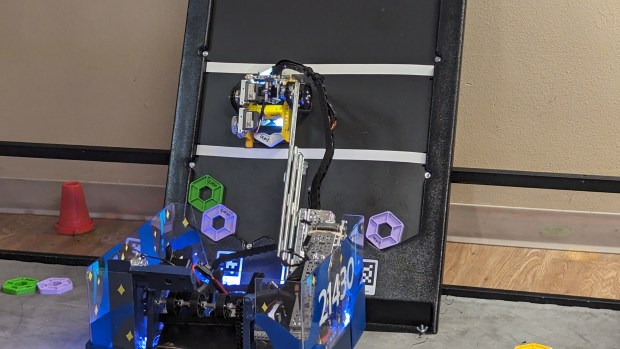 The BroomBots' robot, Zirka, places pixel tiles on a backboard at the world robotics competition in Houston, Texas, in April. (Jamie Rumsey and Julian McCoy -- Courtesy photo)