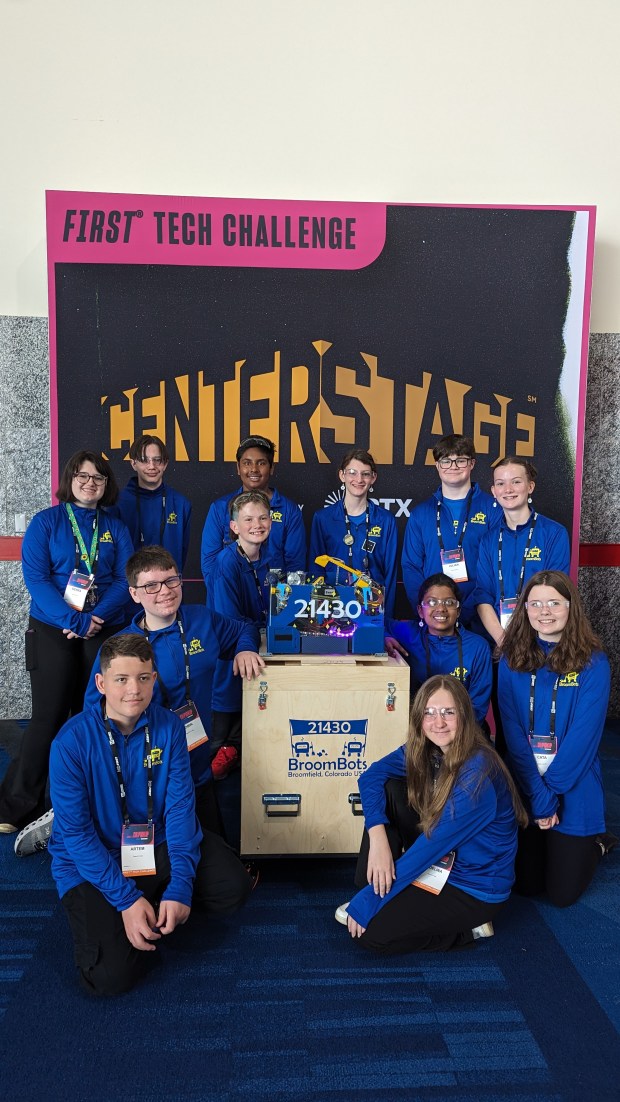 The BroomBots gather around Zirka, the robot, for a photo at the world championship competition in Houston, Texas, in April. (Jamie Rumsey and Julian McCoy -- Courtesy photo)