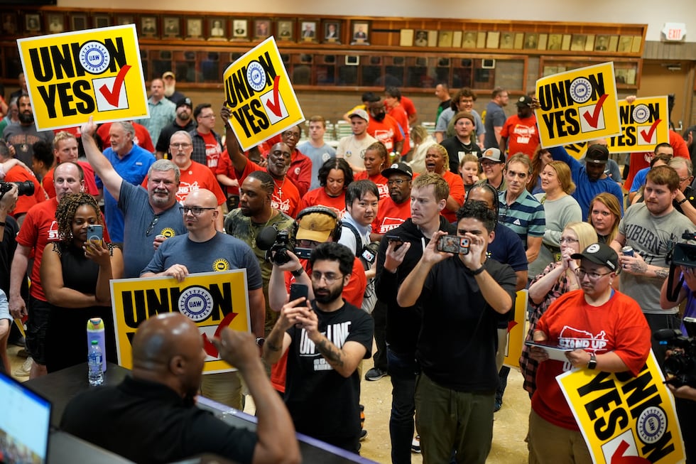 Volkswagen automobile plant employees celebrate winning a vote to join the UAW union Friday,...