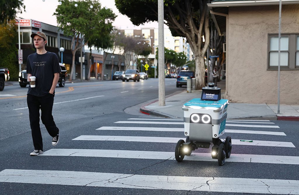 A Serve Robotics autonomous delivery robot, which utilizes AI and is emissions-free, crosses a crosswalk in West Hollywood