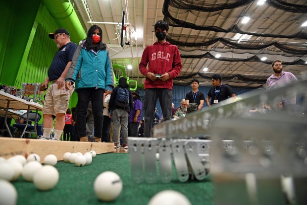 Pursuing a robotics challenge to sweep and contain small balls are (top) Buffalo Grove siblings, from left, Manvitha Yakkali, 13, a seventh-grader and Shreepadh Yakkali, 14, an eighth-grader with their robot named Water Dog during the Lake County Robotics Competition at Maker Faire Lake County on April 13, 2024 at the College of Lake County In Grayslake. (Karie Angell Luc/Lake County News-Sun)