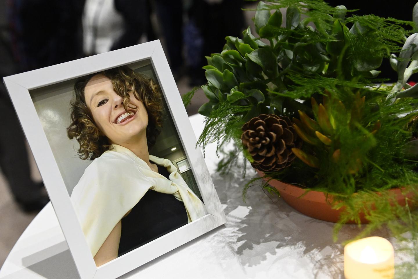 A framed photograph of Pava LaPere sits on a table.