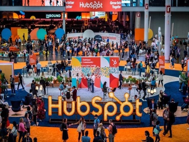 A shot from a second level down on the ground floor where people mingle at HubSpot Inbound 2023.