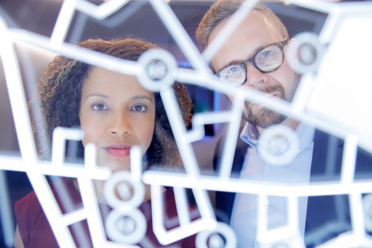 Two people looking at futuristic screen