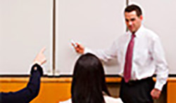 Instructor at white board teaching a class