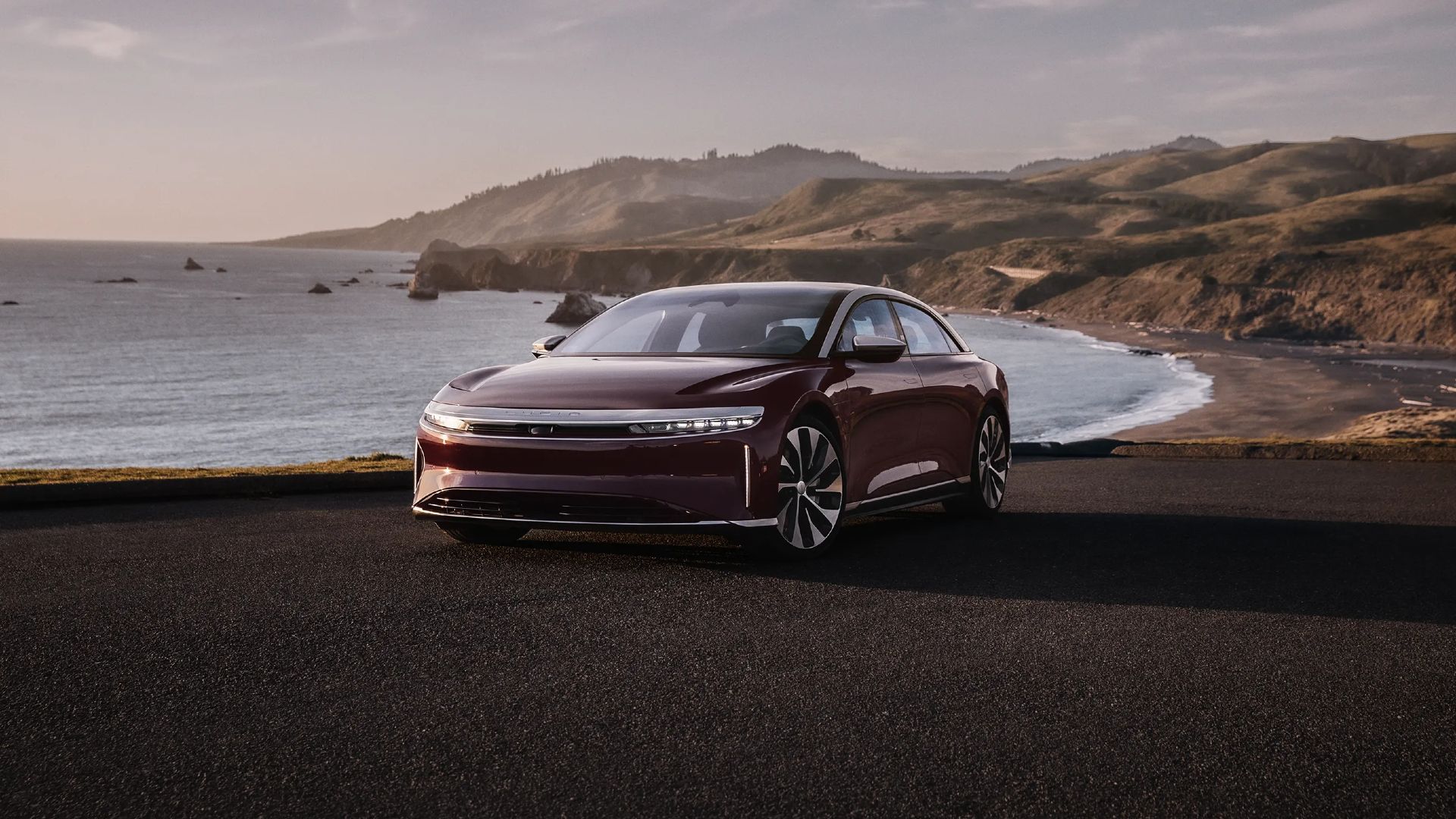 2024 Lucid Air Grand Touring in Zenith Red parked at a beach