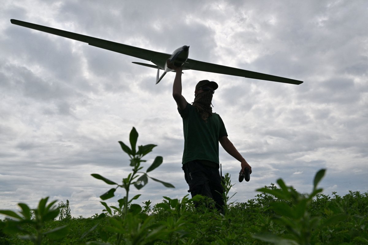 An operator carries a reusable airstrike drone 