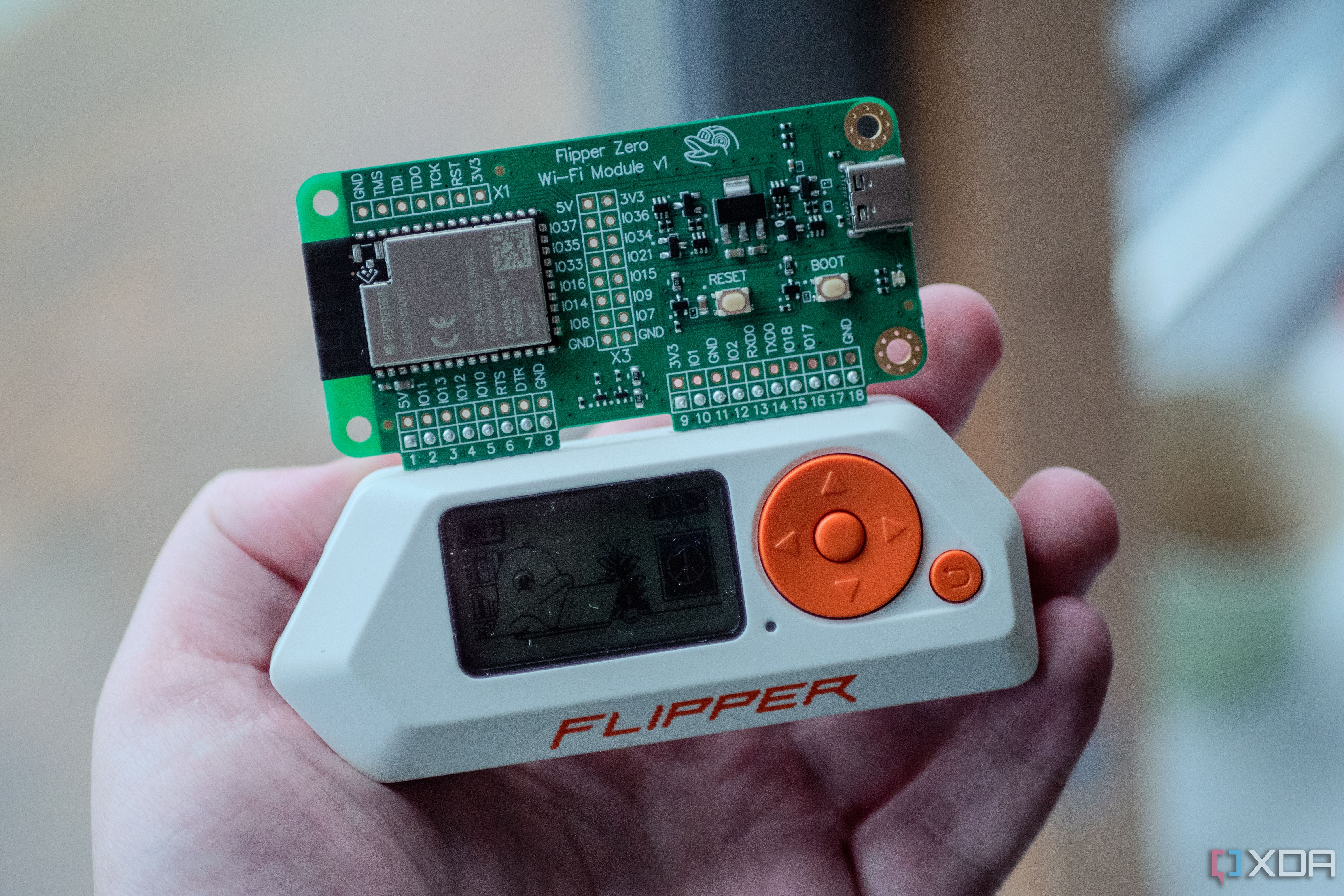 Flipper Zero in-hand with Wi-Fi dev board on top