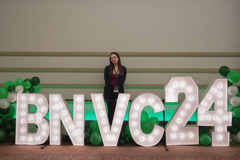 Tanushree Thapar in front of large letters that say BNVC24