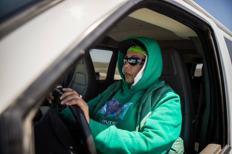 Rafaela Treviño sits in the CalVans van she uses to drive her coworkers and herself, in a cotton field outside of Corcoran, on May 2, 2024. Photo by Larry Valenzuela, CalMatters/CatchLight Local