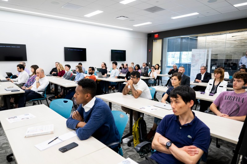 A classroom of audience members listening to Chris Wiggins.