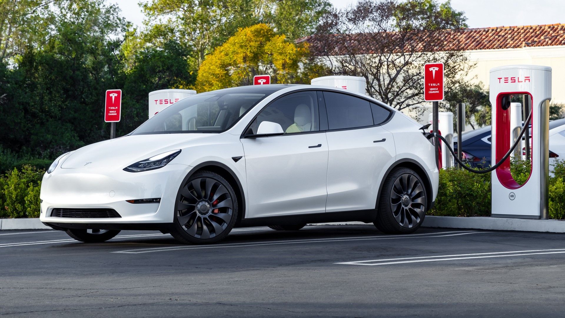 White Tesla Model 3 Performance Charging at a Supercharger