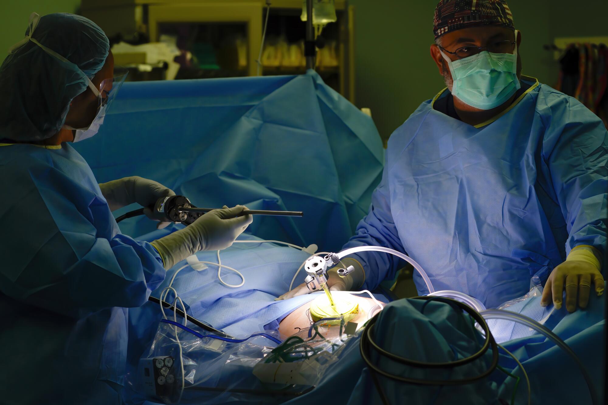 Pamela Lee, MD, left, positions the Da Vinci 5 instrument in place on her patient at Sharp Memorial Hospital.