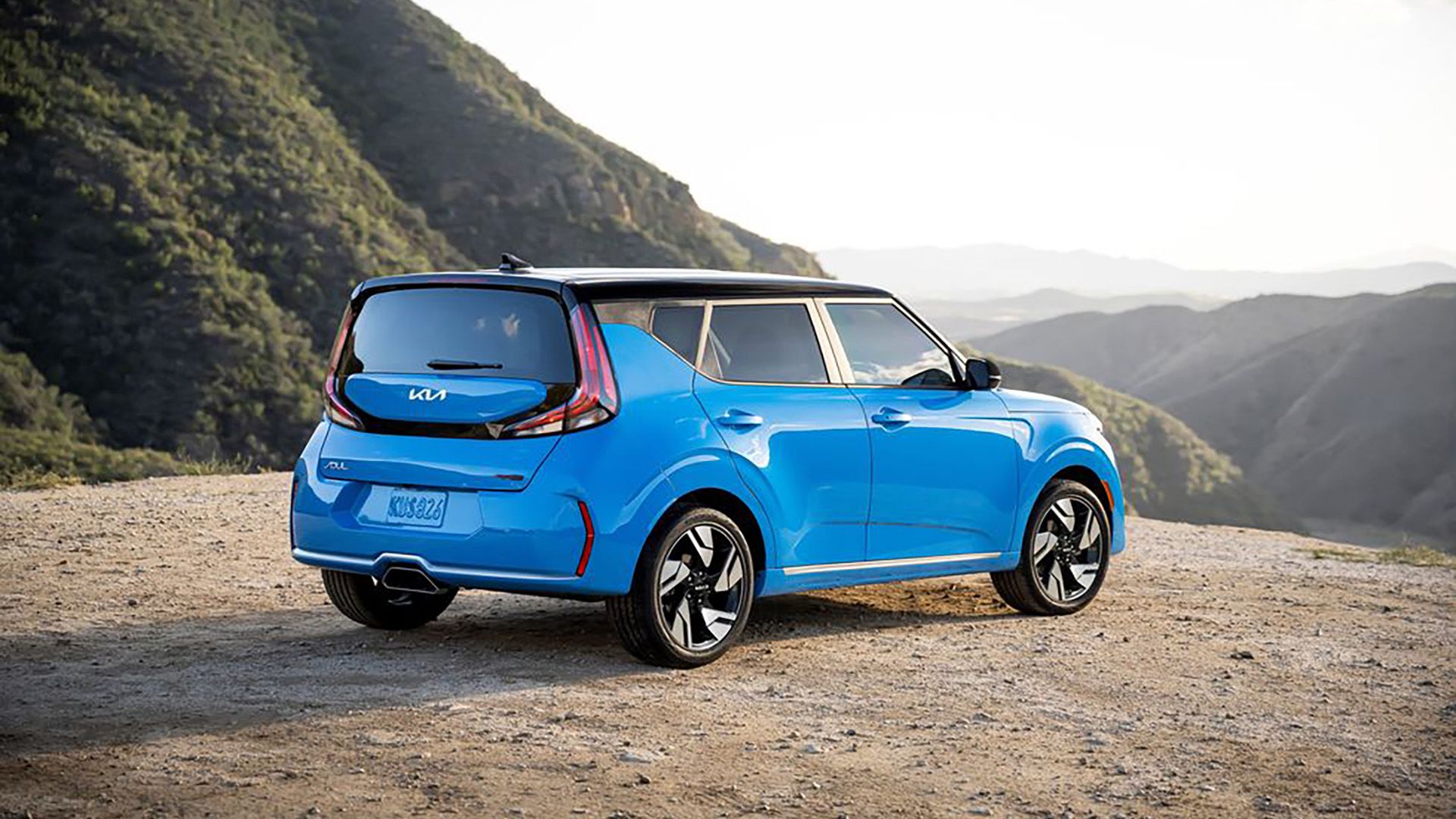 A side on/rear-view shot of a light blue 2023 Kia Soul