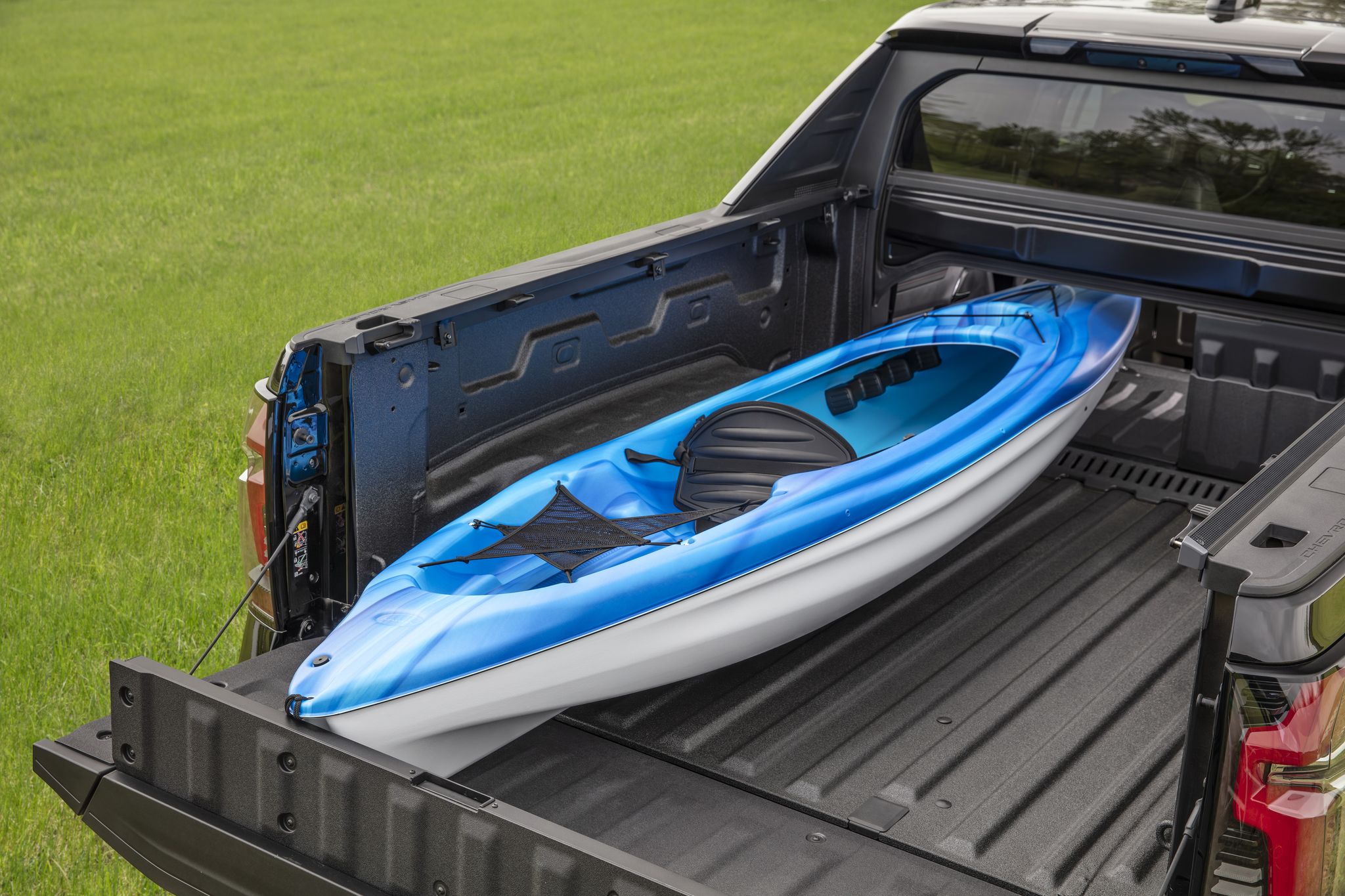 an overhead view showing the 2024 silverado ev multi flex midgate, holding a kayak