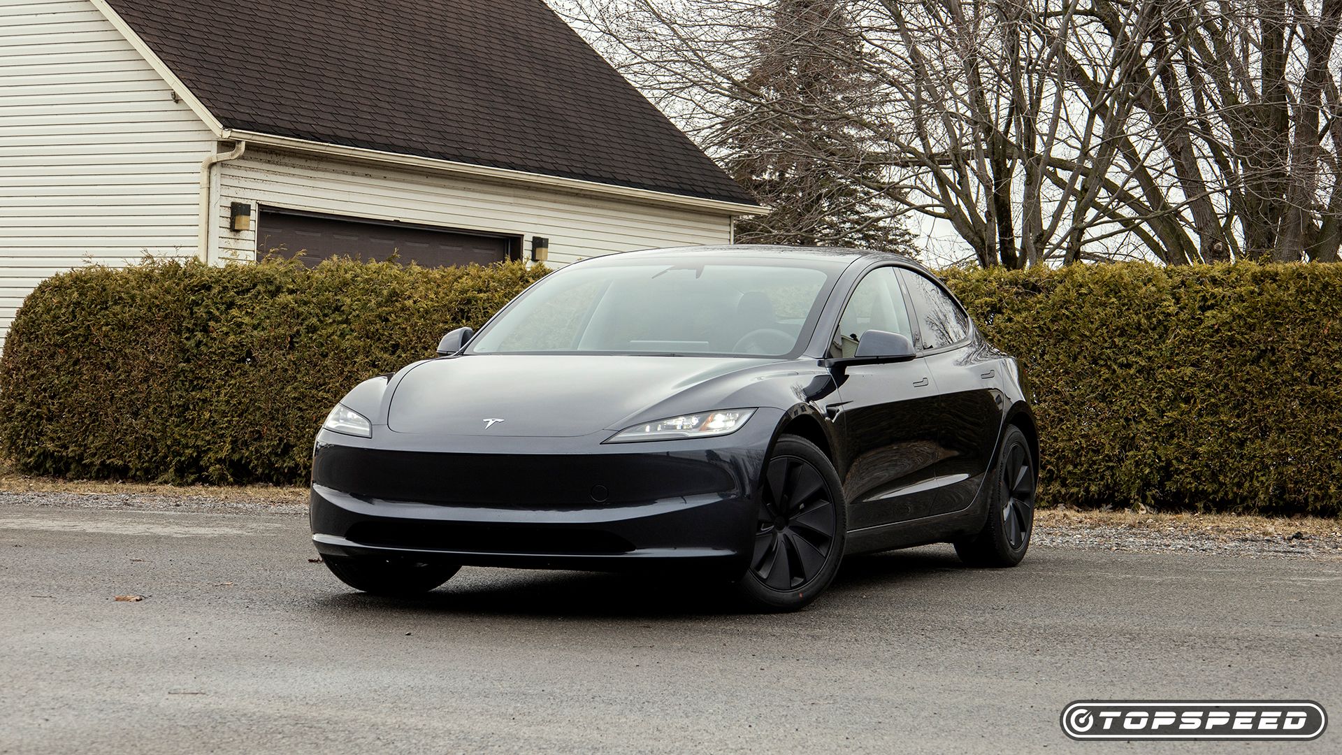 Front three quarters shot of a black 2024 Tesla Model 3 