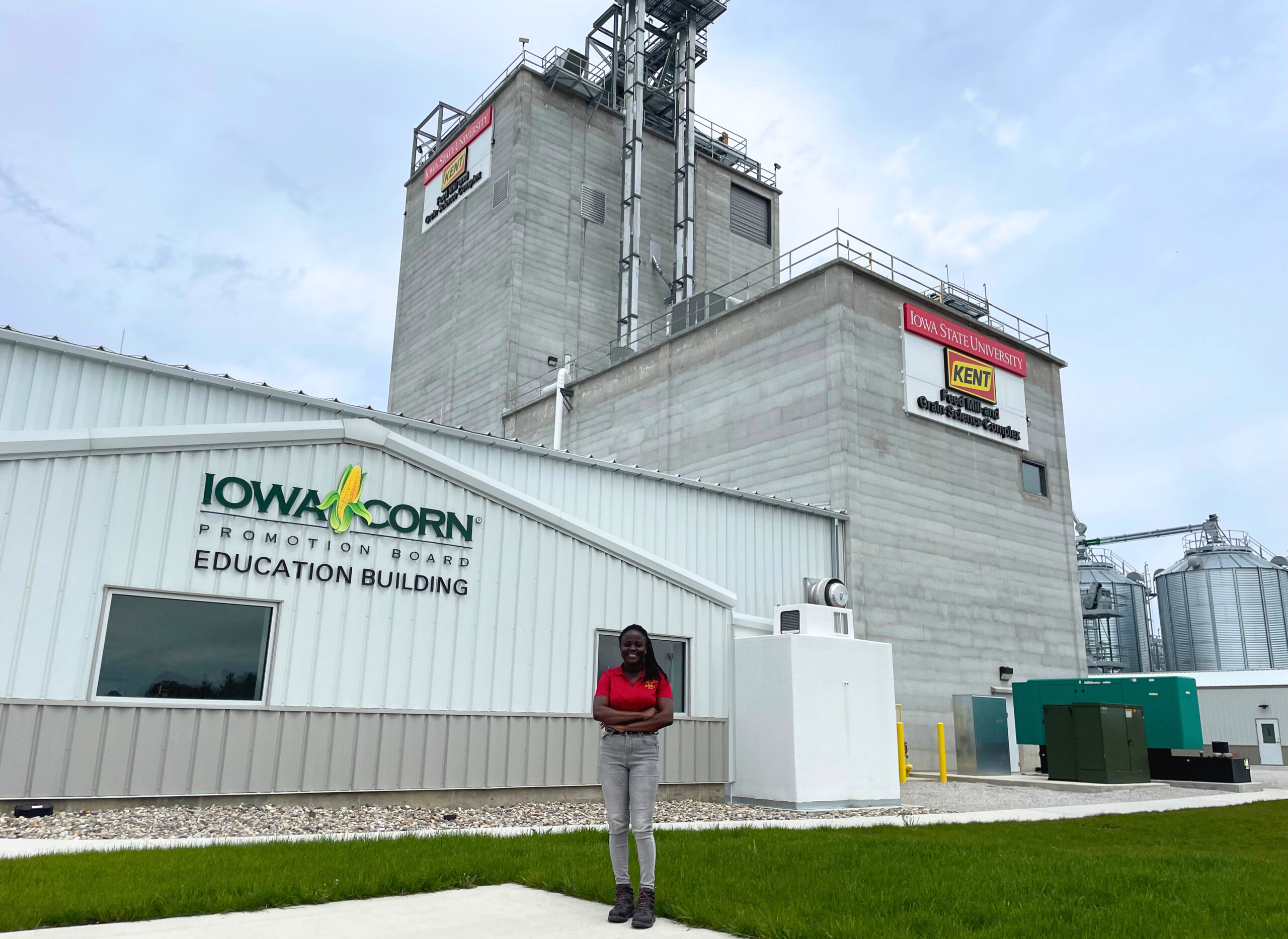 2024-May-9-ABE-Graduate student standing in front of feed mill. 