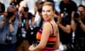 woman in orange and pink striped dress in front of photographers