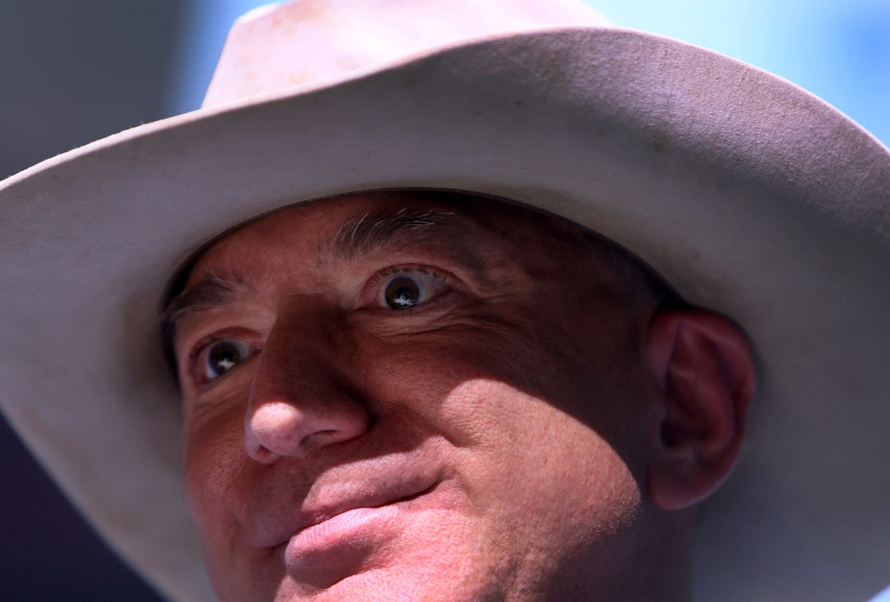 A close-up of Jeff Bezos wearing a white cowboy hat.