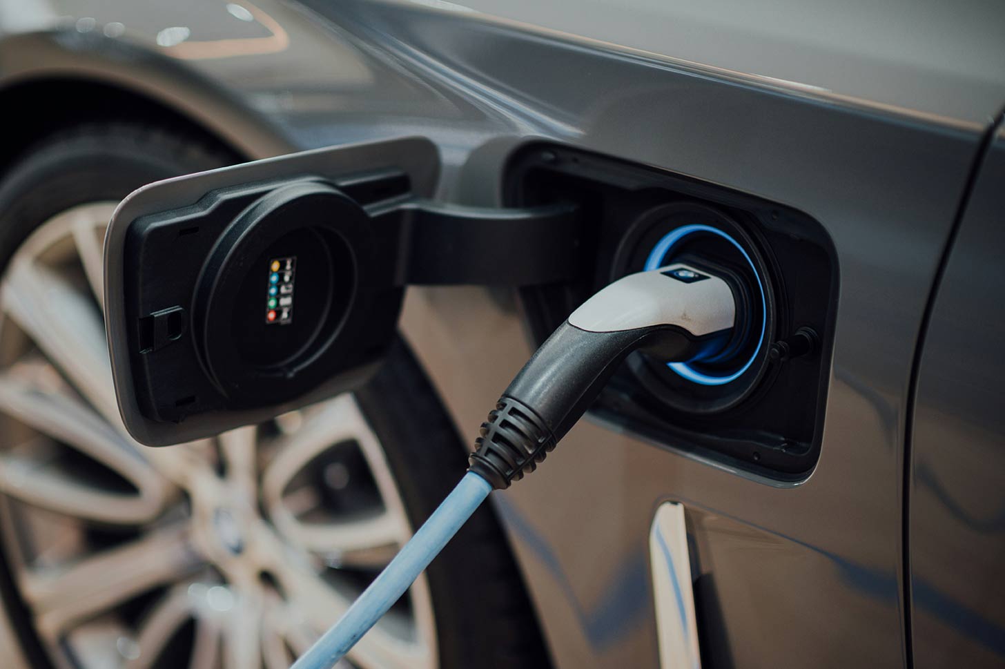 A charger plugged in to an electric car