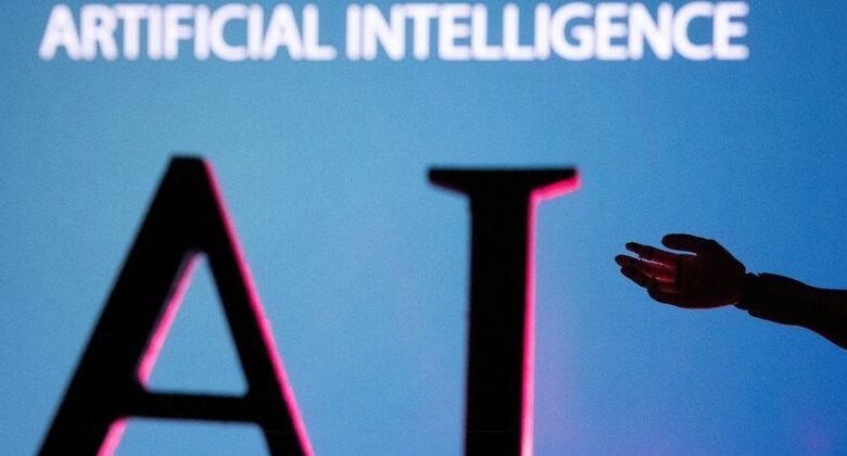FILE PHOTO: Illustration shows AI (Artificial Intelligence) letters and robot hand miniature – Arizona Daily Sun FILE PHOTO: Illustration shows AI (Artificial Intelligence) letters and robot hand miniature – Arizona Daily Sun