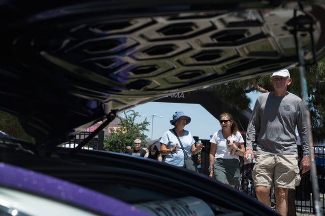 Visitors check out the customized electric vehicles display at the Electrify Expo outside State Farm Stadium on May 4, 2024 in Glendale, Ariz.